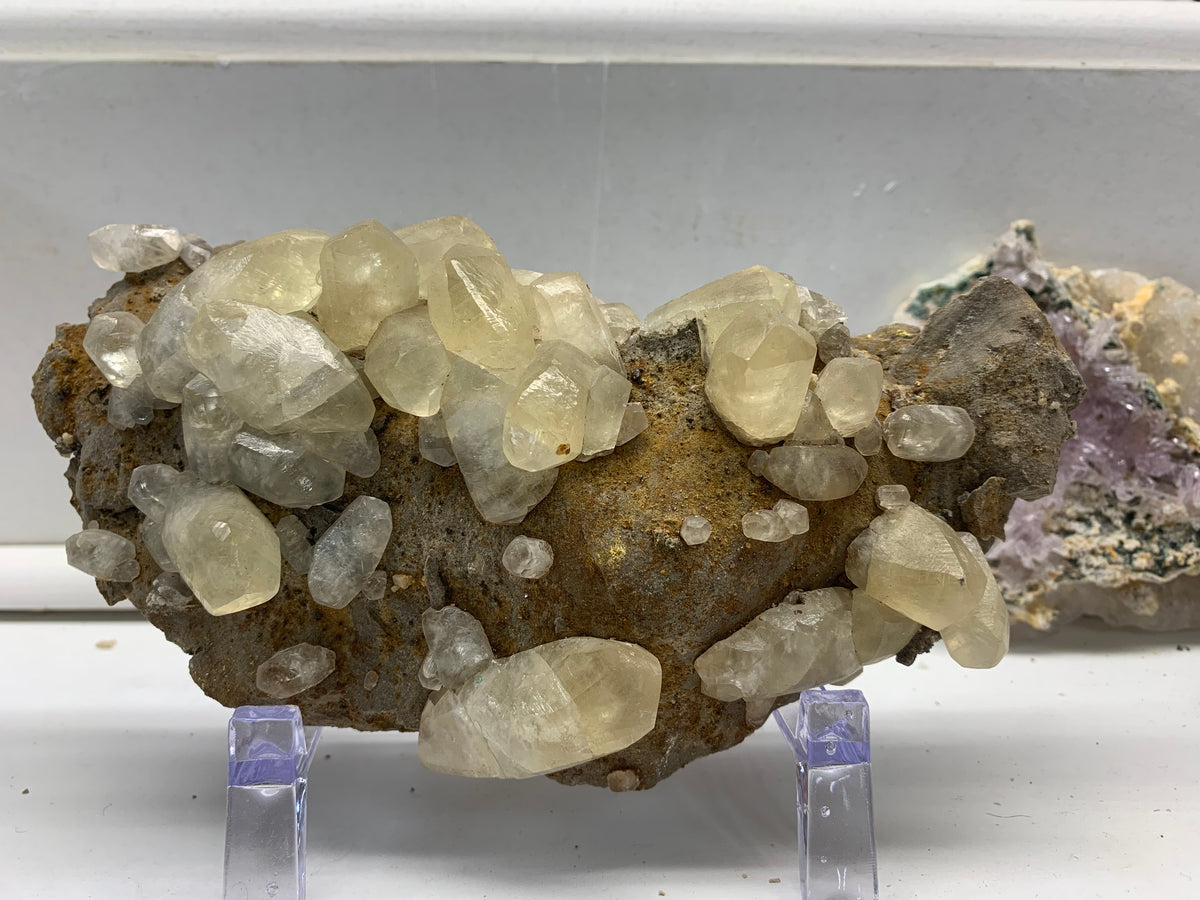 Natural pale calcite crystal specimen from the Elmwood Mine in Carthage, Tennessee, displayed at Earthforged Rock Shop.