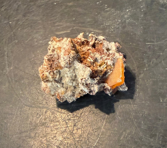 Natural wulfenite mineral specimens with orange and yellow crystal formations on matrix at Earthforged Rock Shop.