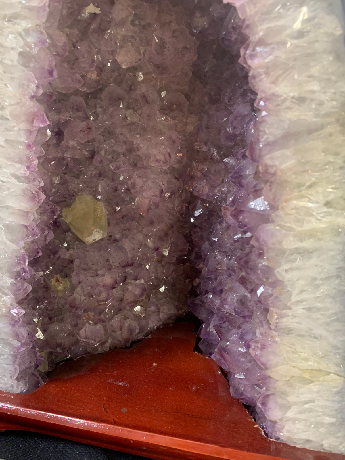 Close-up of secondary crystal formation growing among purple amethyst crystals