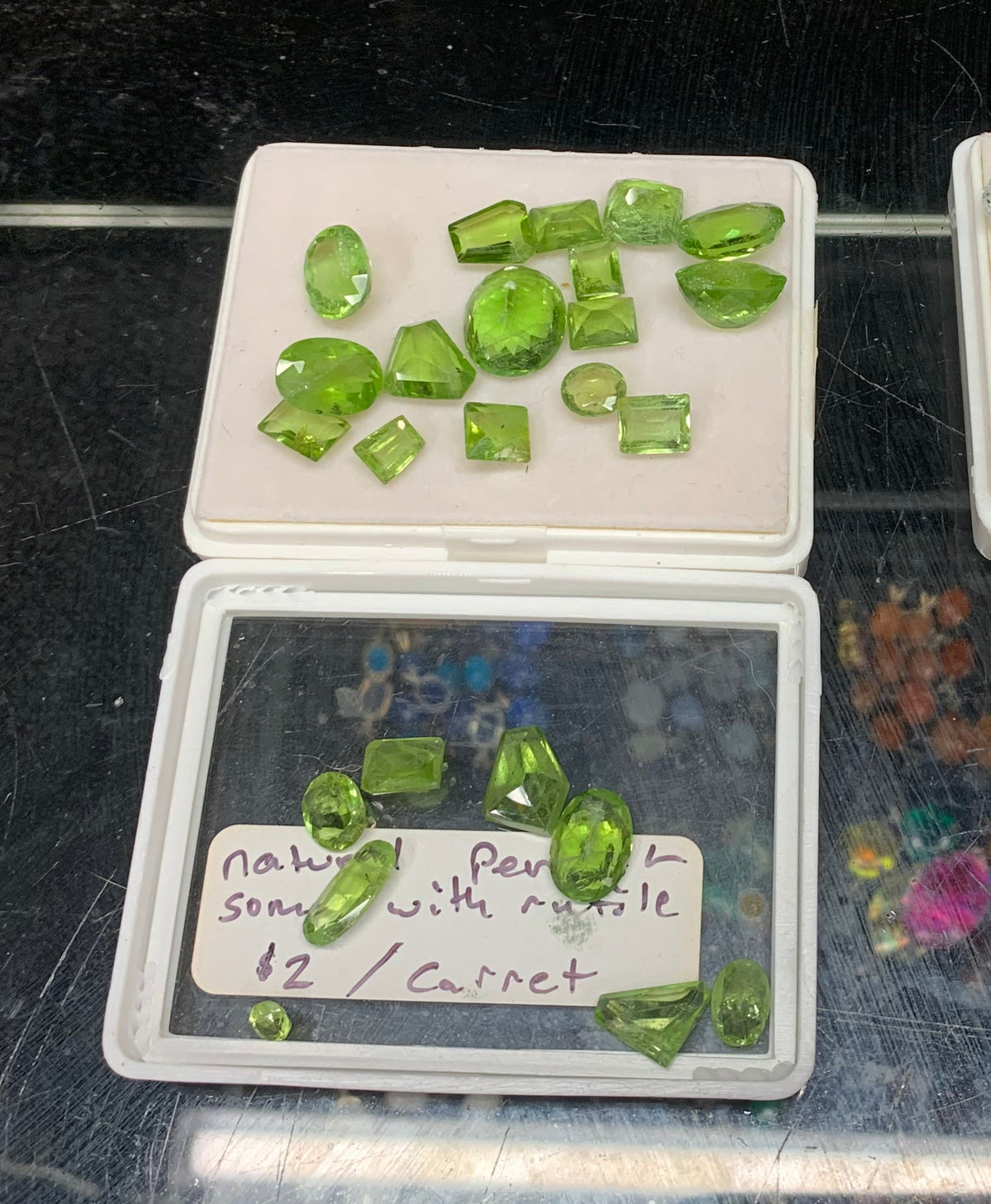 Natural cut green peridot gemstones sold by carat at Earthforged Rock Shop, with select stones containing rutile inclusions.