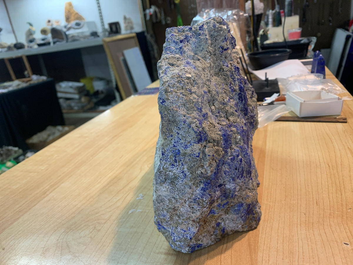 Natural lapis lazuli specimen viewed from the opposite side showing blue and gray matrix
