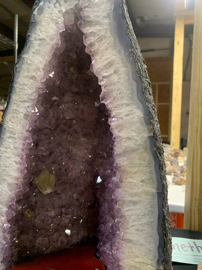 Close-up of amethyst crystal points inside cathedral geode