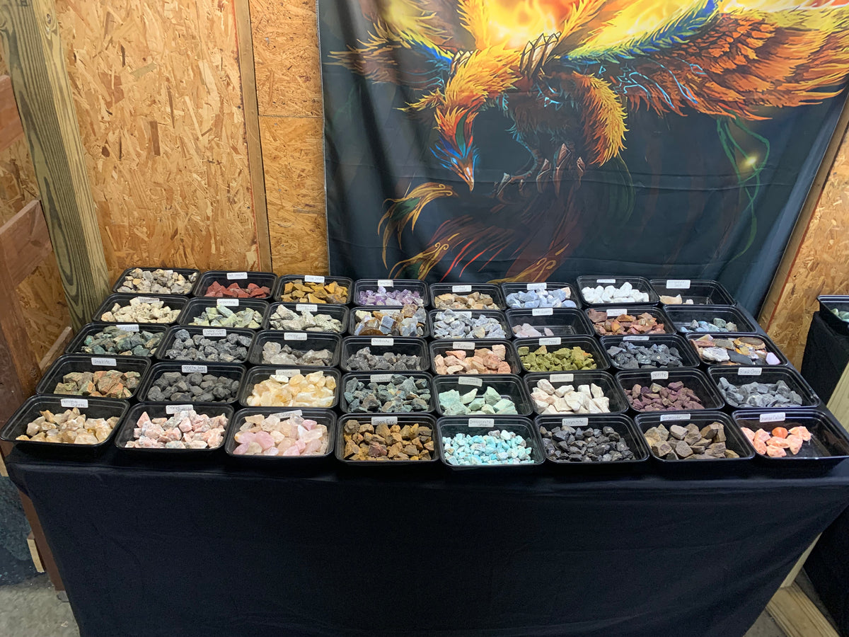 Trays of colorful raw stones, crystals and mineral specimens at Earthforged.
