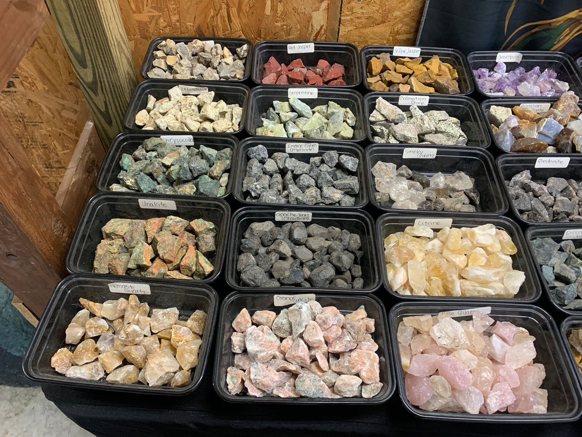 Assorted natural raw stones, crystals and mineral specimens displayed at Earthforged Rock Shop.