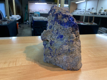 Angled view of raw lapis lazuli specimen showing natural texture and blue coloration