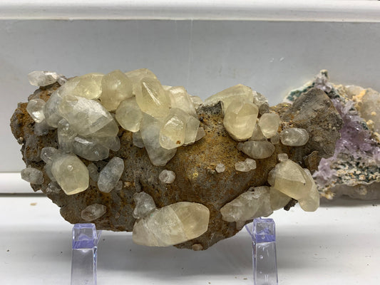 Natural pale calcite crystal specimen from the Elmwood Mine in Carthage, Tennessee, displayed at Earthforged Rock Shop.