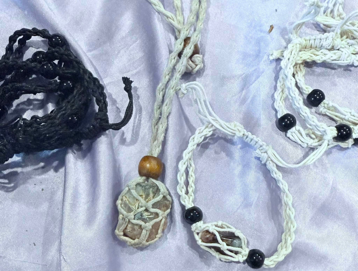 Black and natural macramé stone holder necklaces and bracelets shown with crystals and tumbled stones