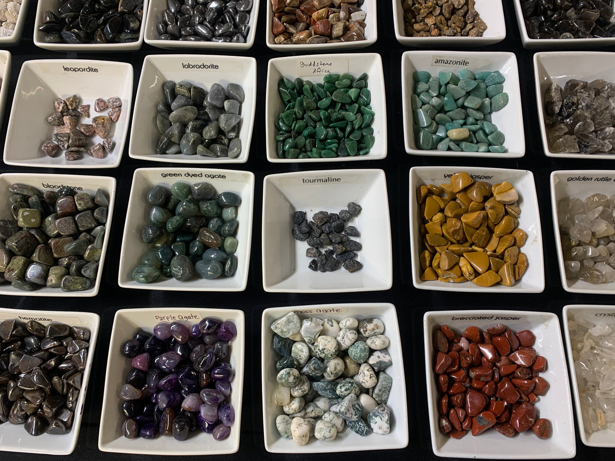 Assorted raw, polished, and tumbled crystal stones available in Earthforged's $1 stone collection.