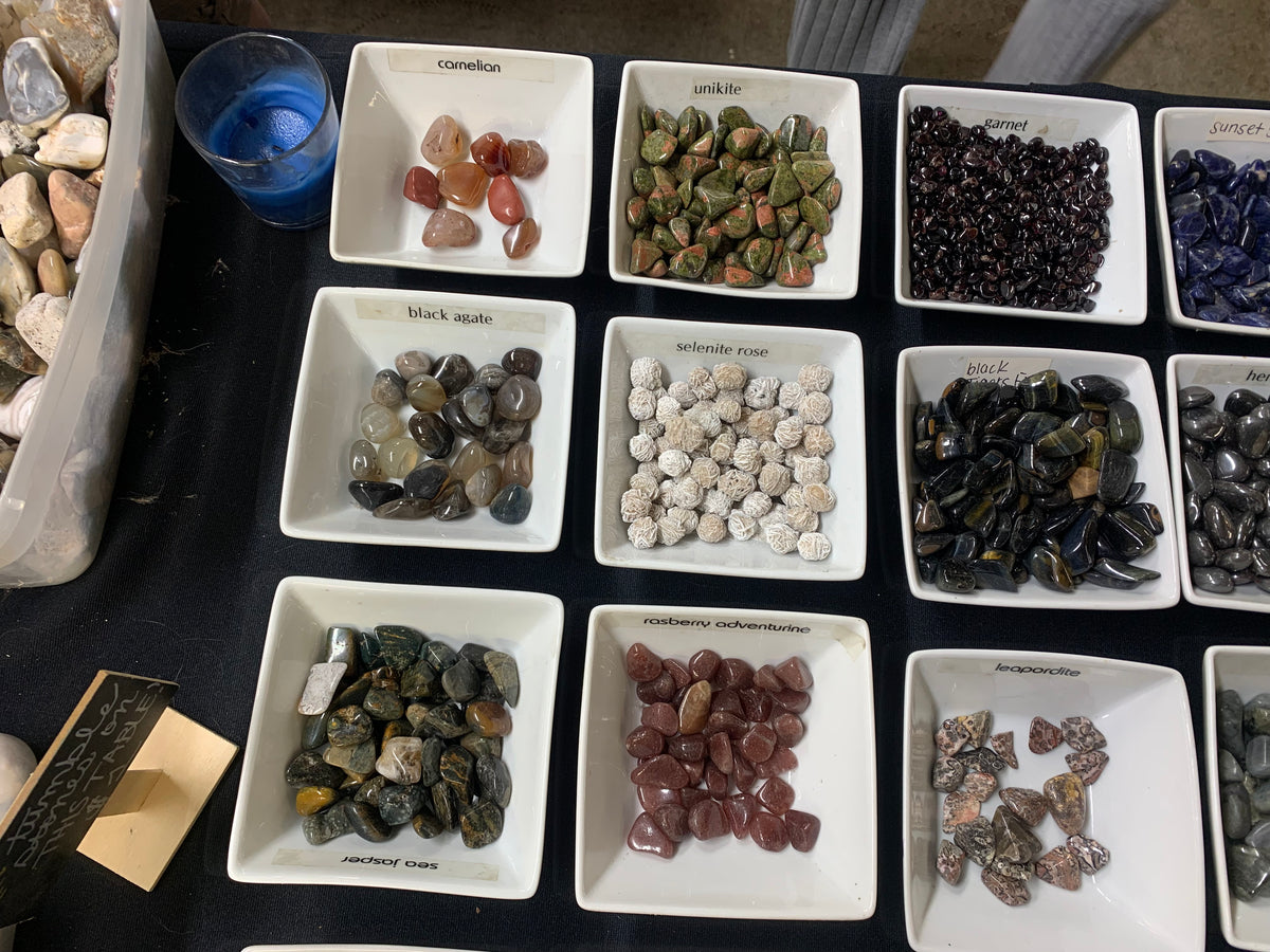 Assorted raw, polished, and tumbled crystal stones available in Earthforged's $1 stone collection.